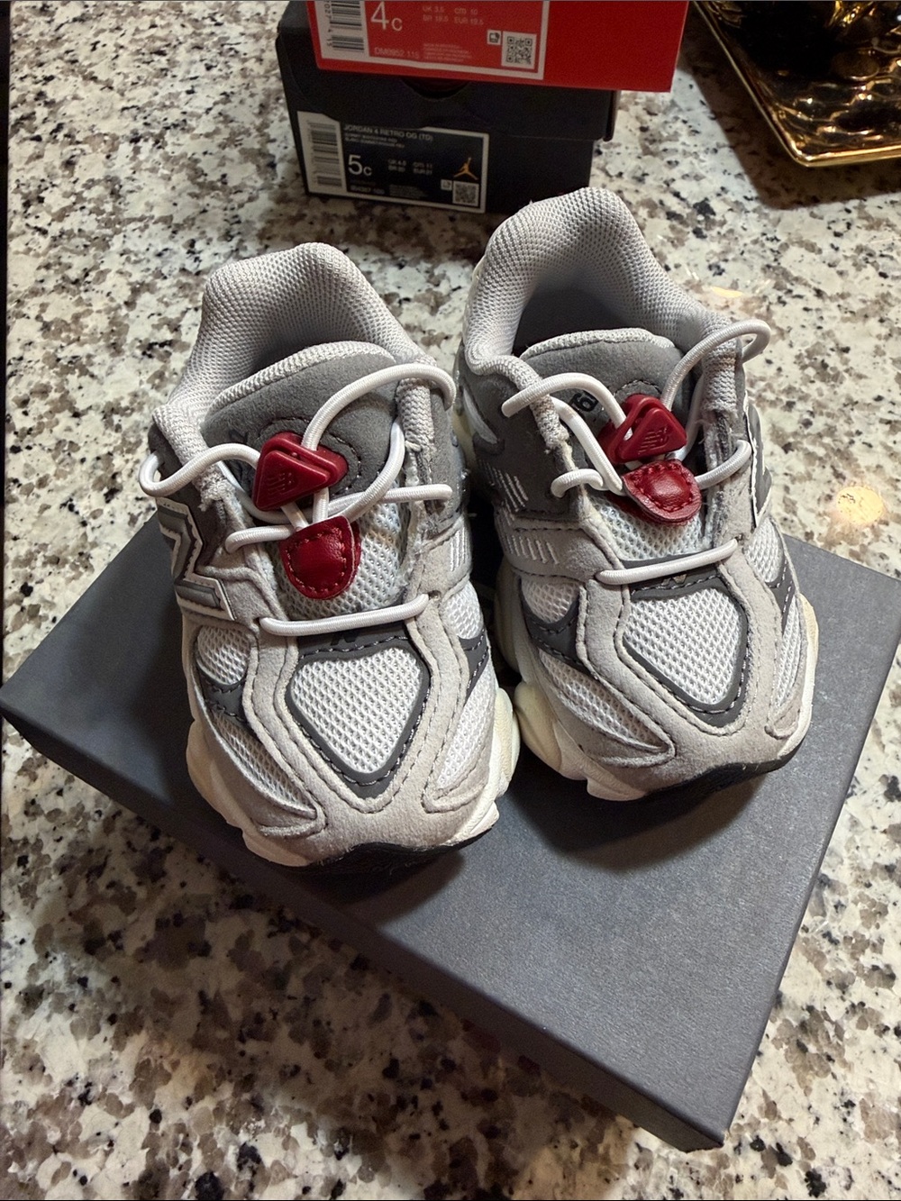New Balance Kids Gray Sneakers with Red Toggle